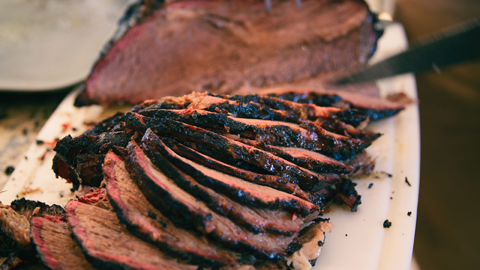 Sliced smoked beef brisket with nice smoke ring.