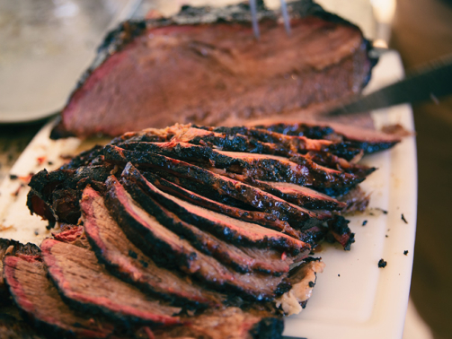Sliced smoked beef brisket with nice smoke ring.